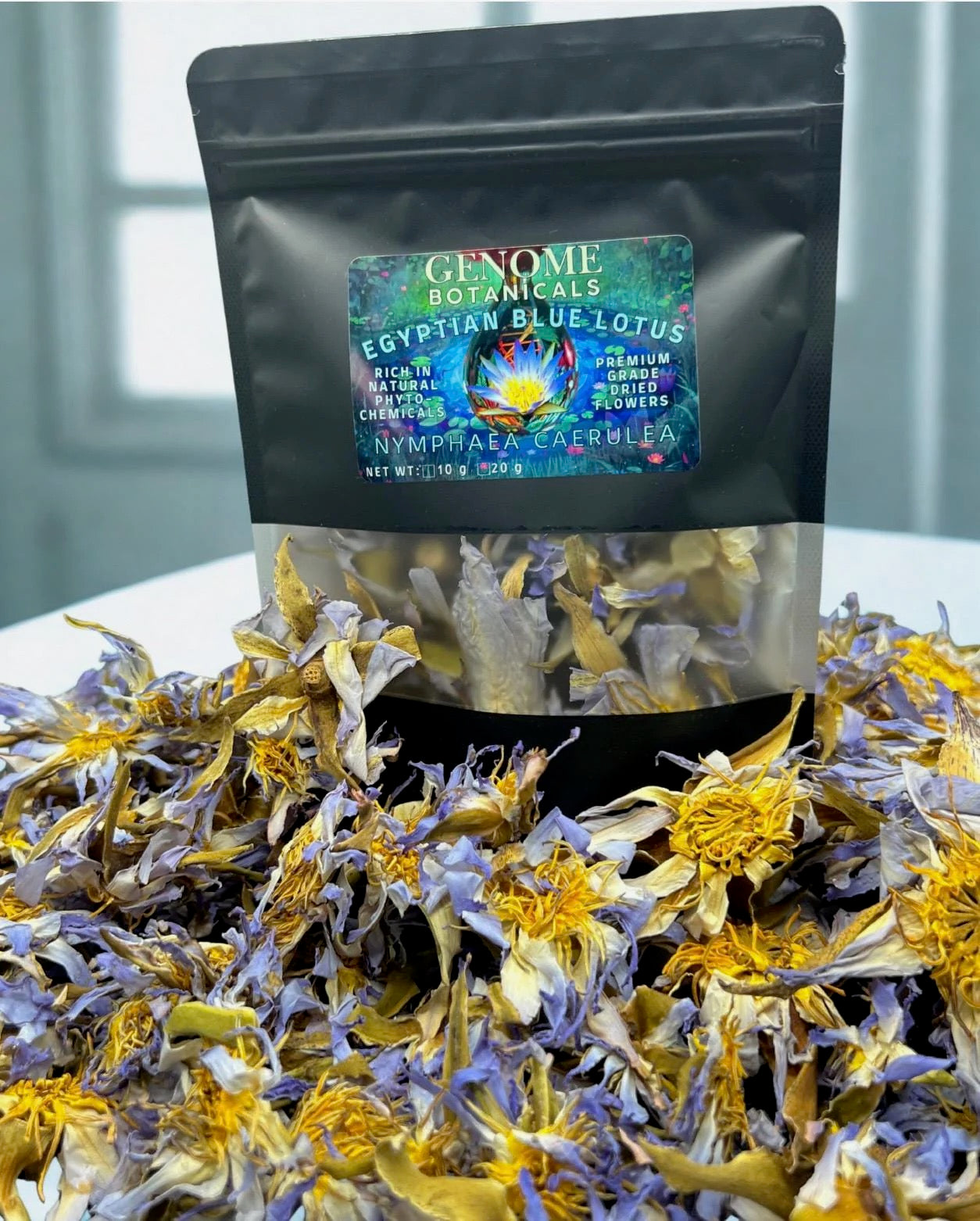 Egyptian Blue Lotus 10 gram package surrounded by true Nymphaea caerulea flowers